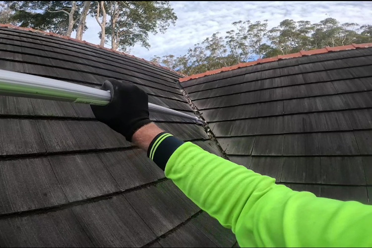 Thorough gutter cleaning with an extended pole for pristine valleys on a steep roof in batemansbay
