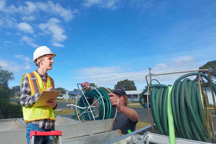 batemansbay gutter cleaning expert prepares his hose system after gutter rinsing.